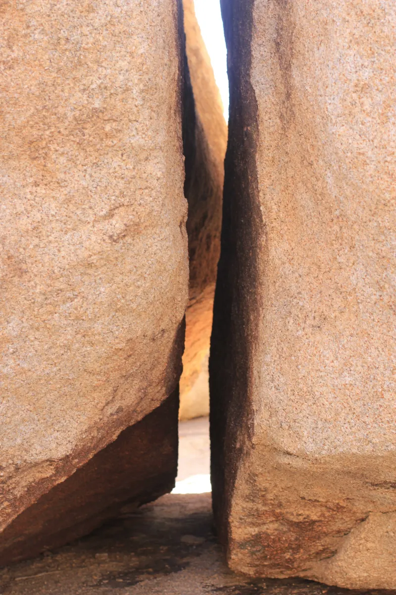 A narrow gap between two huge sandstone boulders